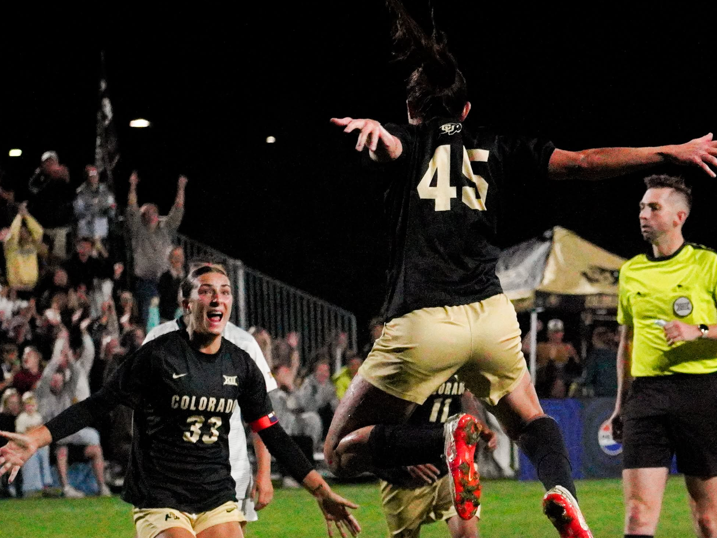 Hope Leyba (45) leaps after scoring in the 36th minute as Reagan Kotschau, who headed the ball on to her, runs in to celebrate against No. 10 West Virginia at Prentup Field on Thursday. It was the 39th goal of Leyba's career, tying Taylor Kornieck for third in program history. (Sam Ackerman / FRSN)
